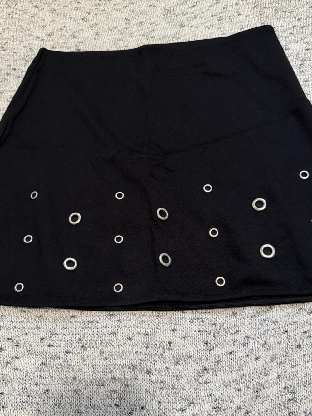 Divided Black Mini Skirt with Silver Eyelet Detail